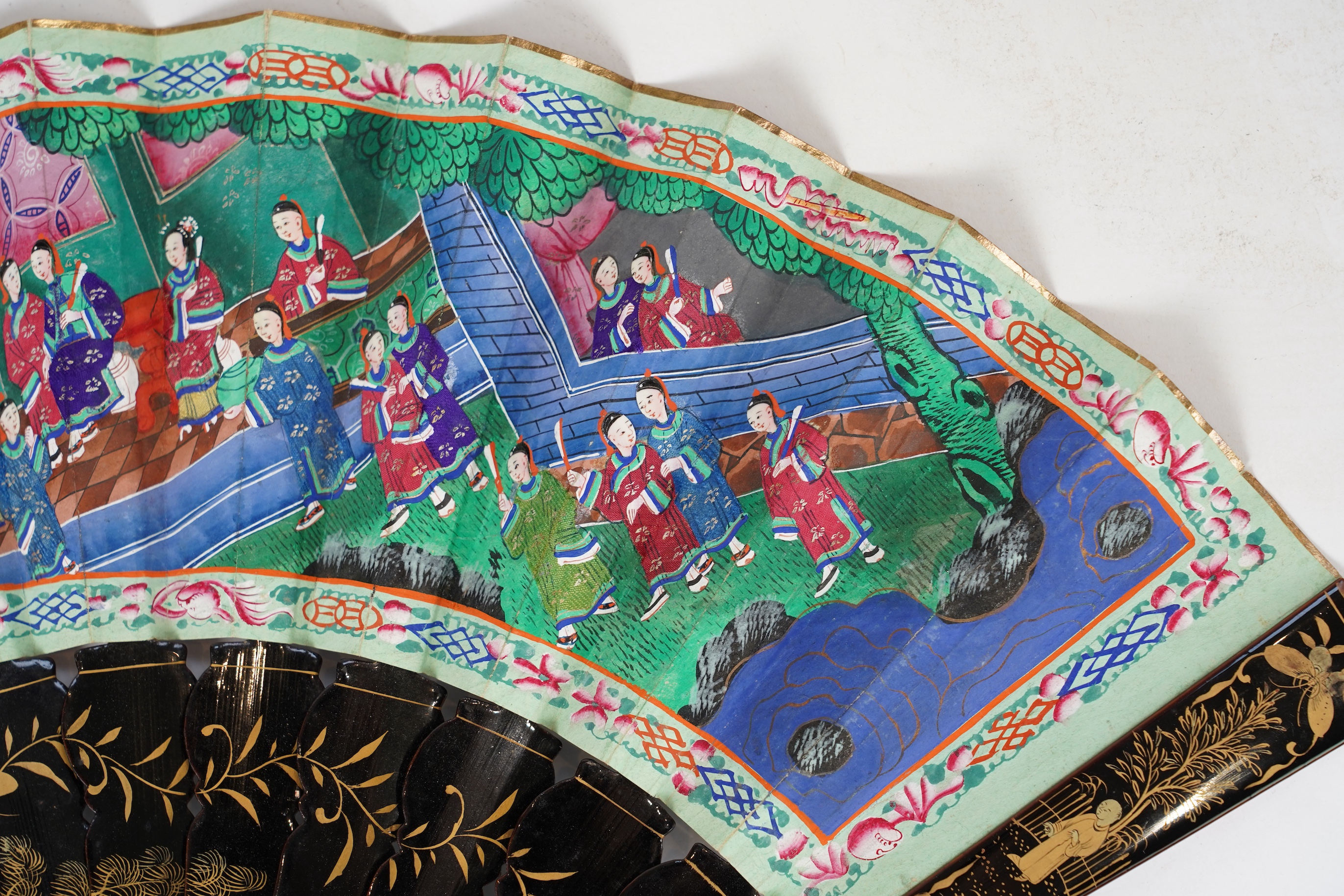 Three Chinese gilt-decorated black lacquer and painted leaf fans, 19th century